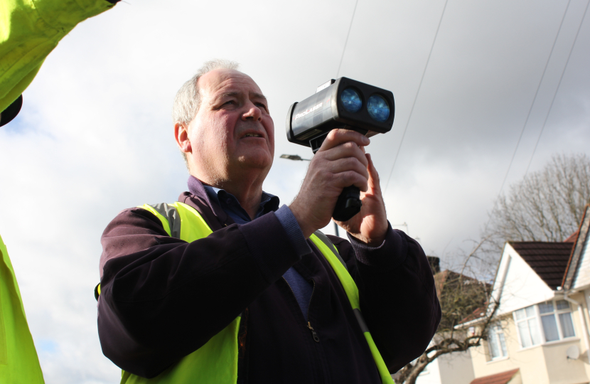 Bob Blackman holding a speed gun at the Community Roadwatch session.